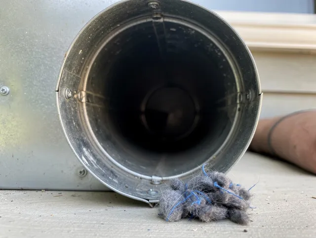 Lynwood Dryer Vent Cleaning technician using specialized equipment to clear severe dryer vent blockage in Lynwood